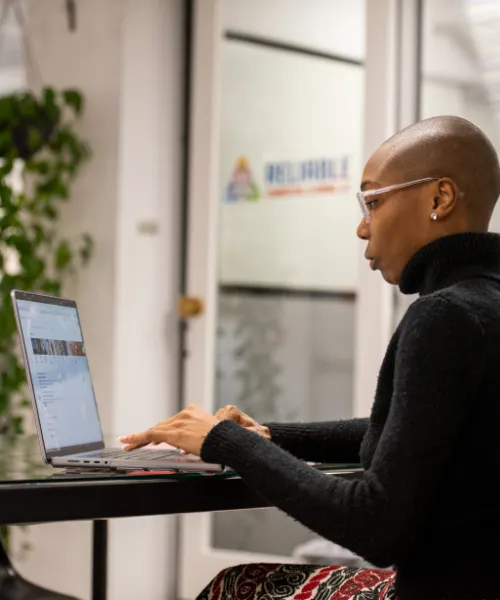 Monique Pour of Click Control Marketing typing on a laptop.