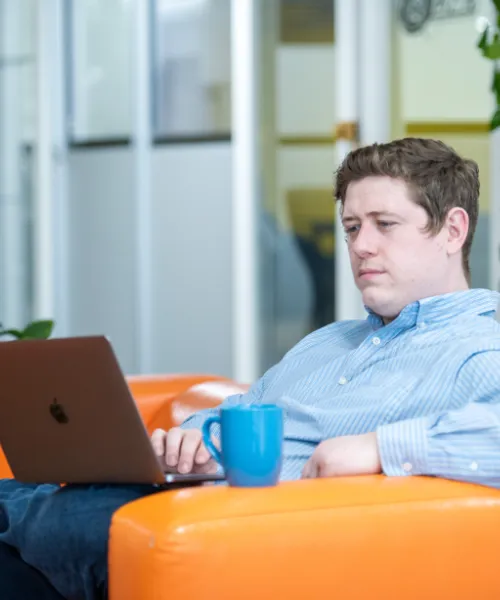 Ryan Glumm of Click Control Marketing working on Mac laptop.