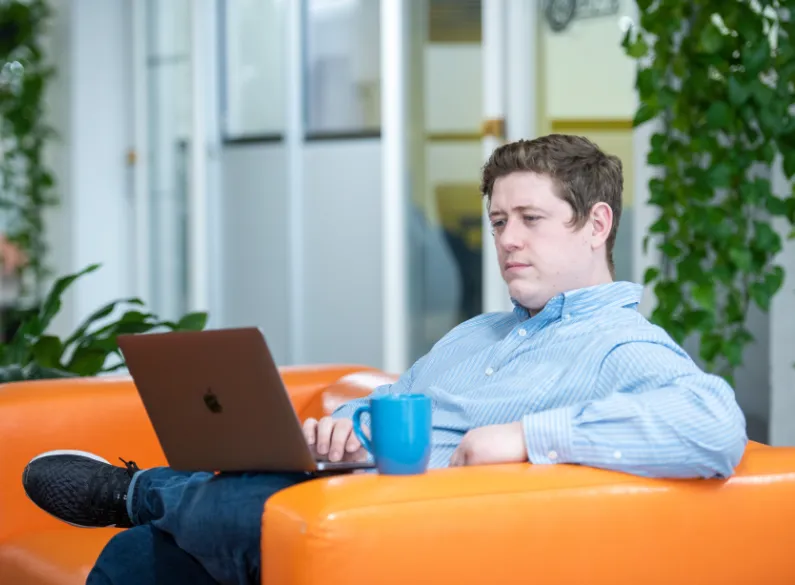 Ryan Glumm of Click Control Marketing working on Mac laptop.